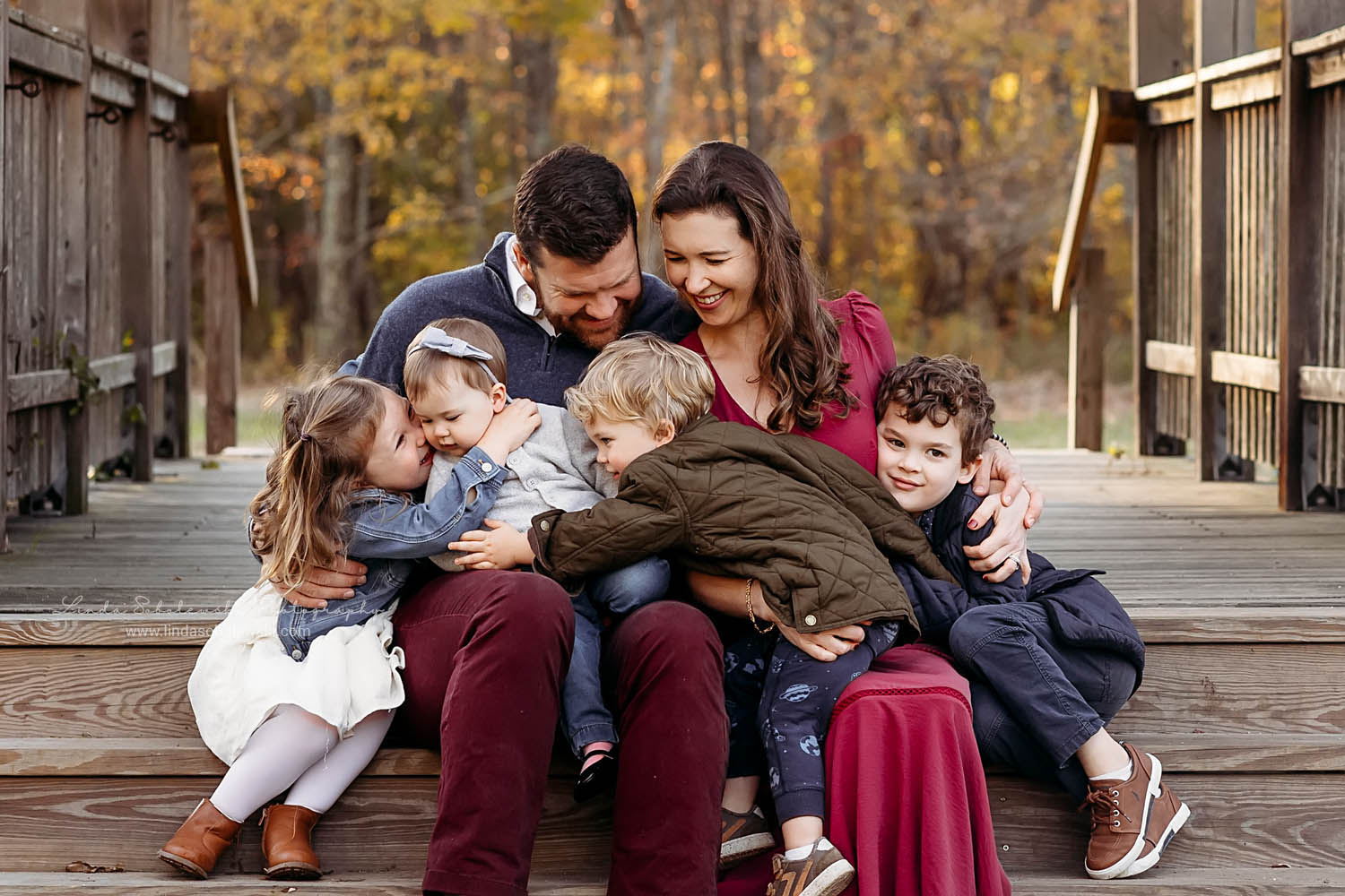 family of six sitting on a bridge, Outdoor family photo- sessions on the CT shoreline