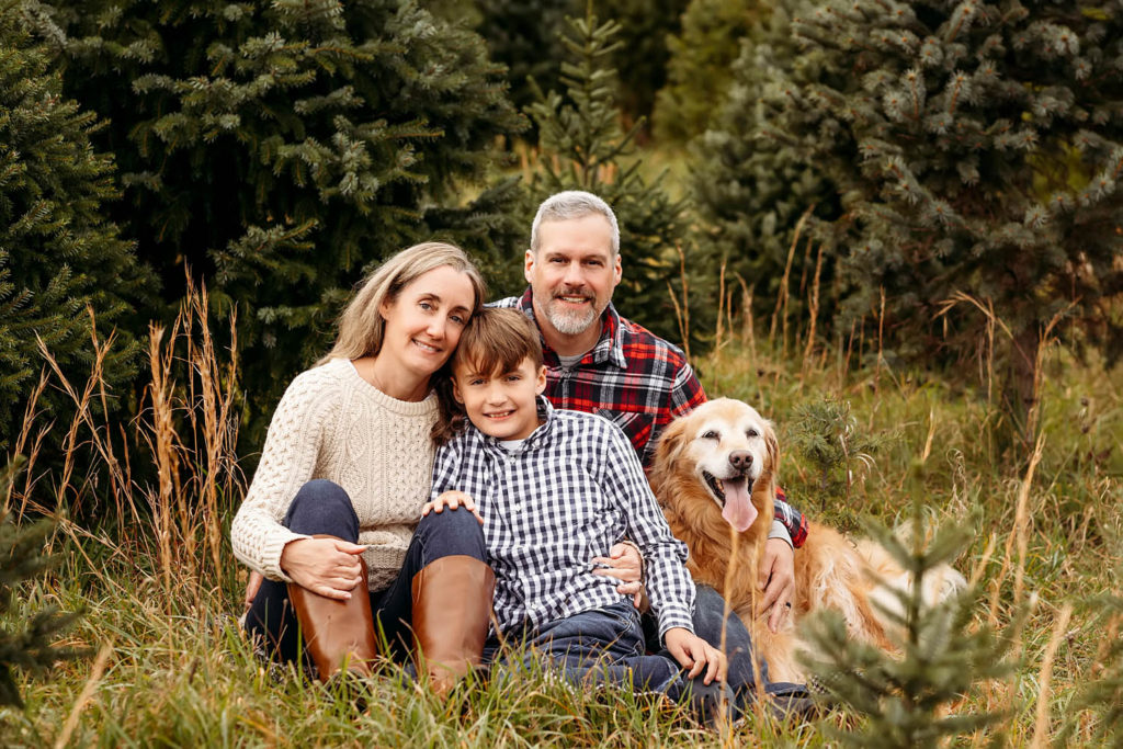family of three with their dog at the tree farm. Guilford CT Family photographer