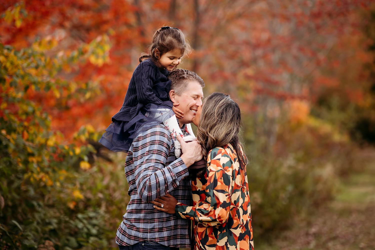 family of three at the park during fall, CT family photographer