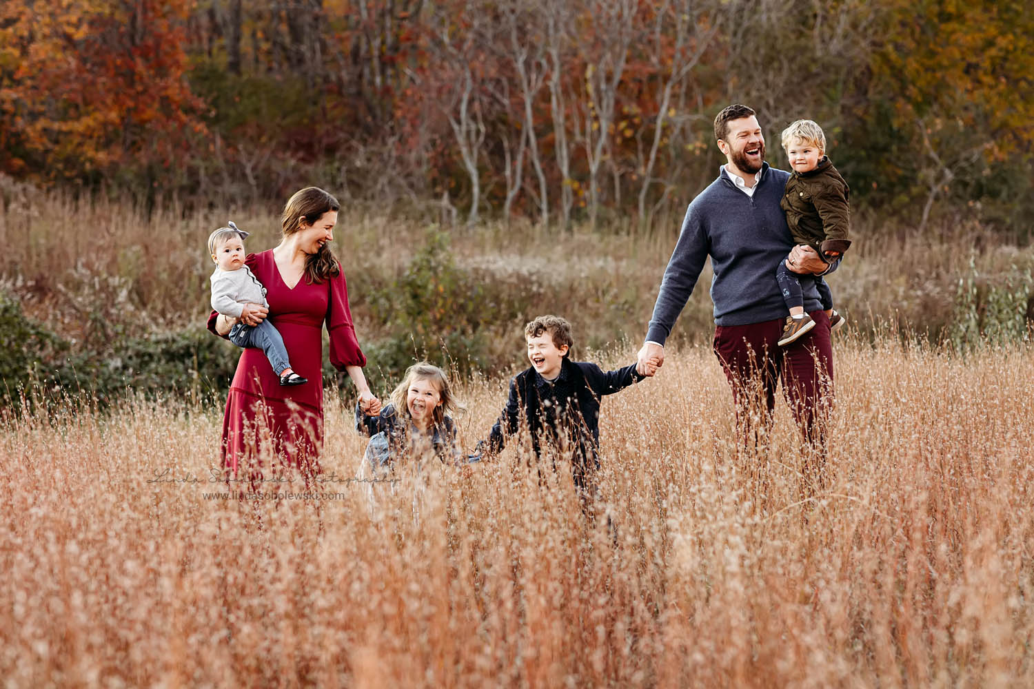 family with four children walking in the grass together, CT Shoreline Family photographer