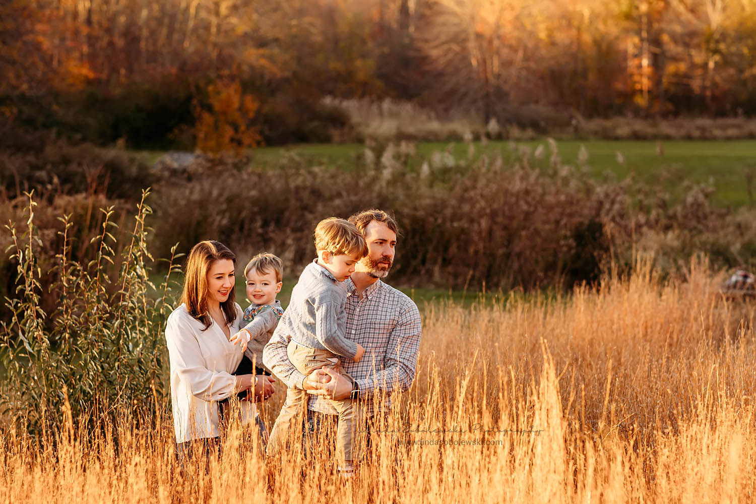 family of four walking in weeds, Old Lyme CT Family photographer