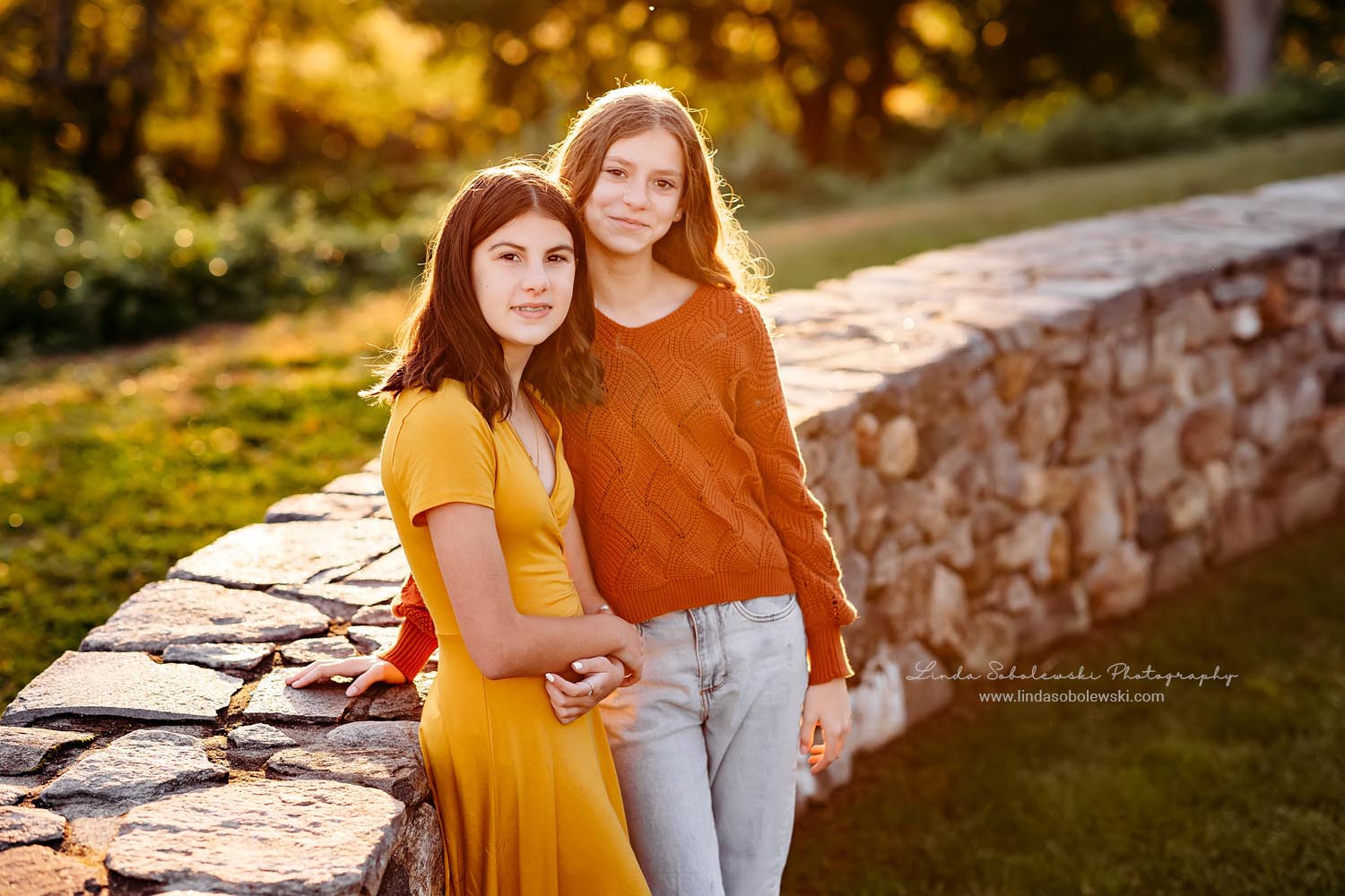 two girls leaning against a brick wall, Essex and Old Lyme Family photographer