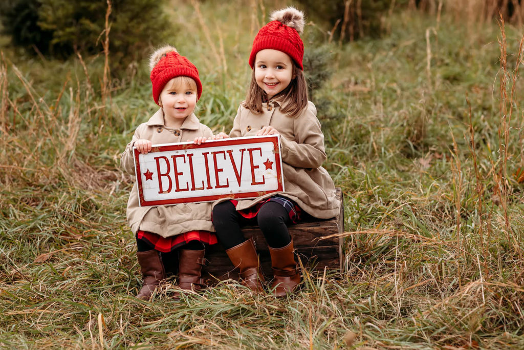 sisters with red hats sitting on a wooden box, CT shoreline photographer