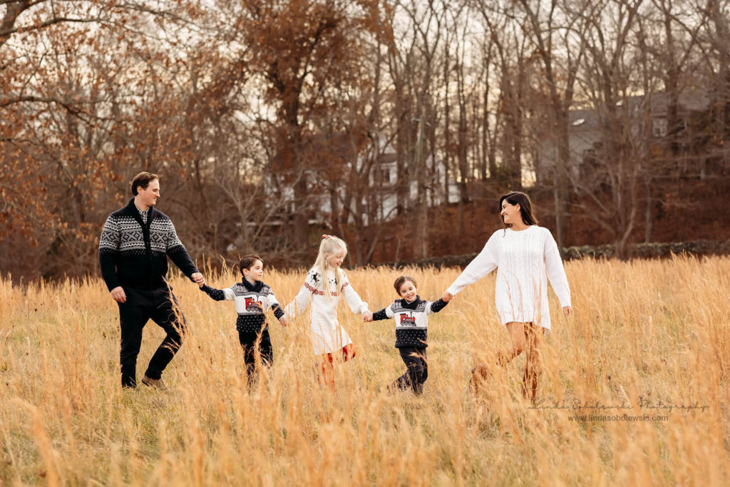 family of five walking together in a field, Lyme CT Family photographer
