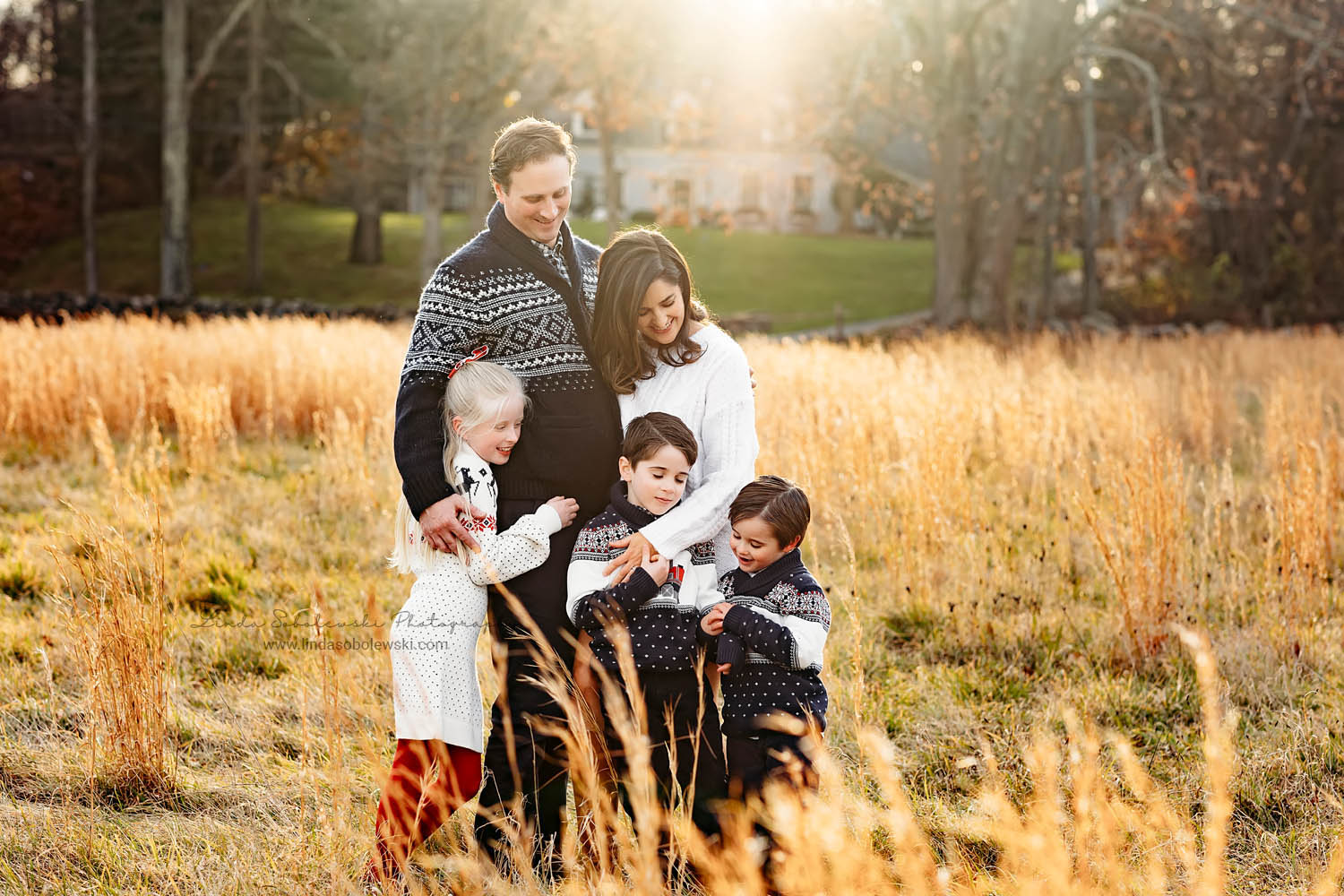 family of five hugging each other at a Christmas Tree Farm photo session