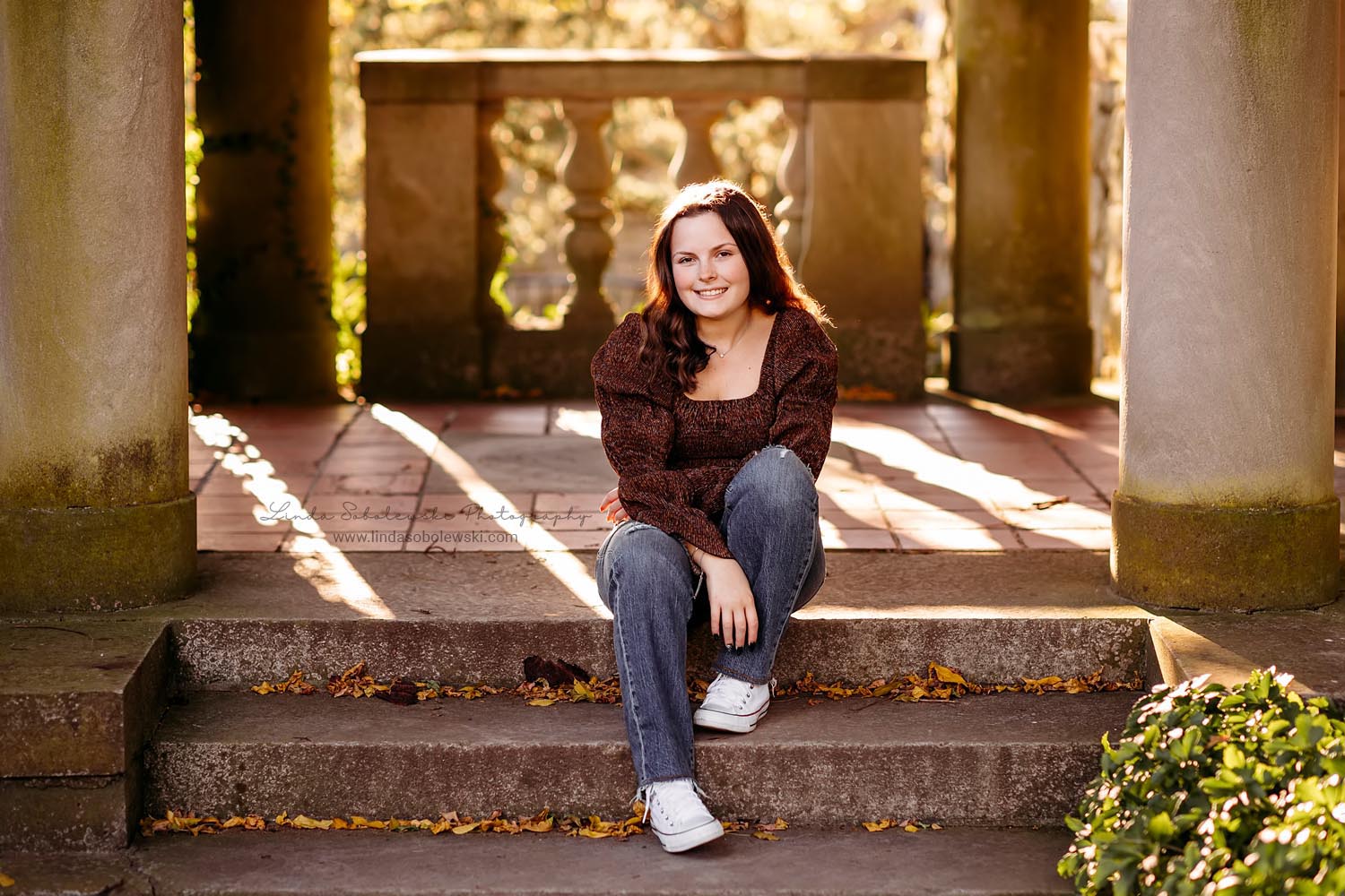 girl in brown sweater sitting on stone steps, Lyme CT Senior Photographer