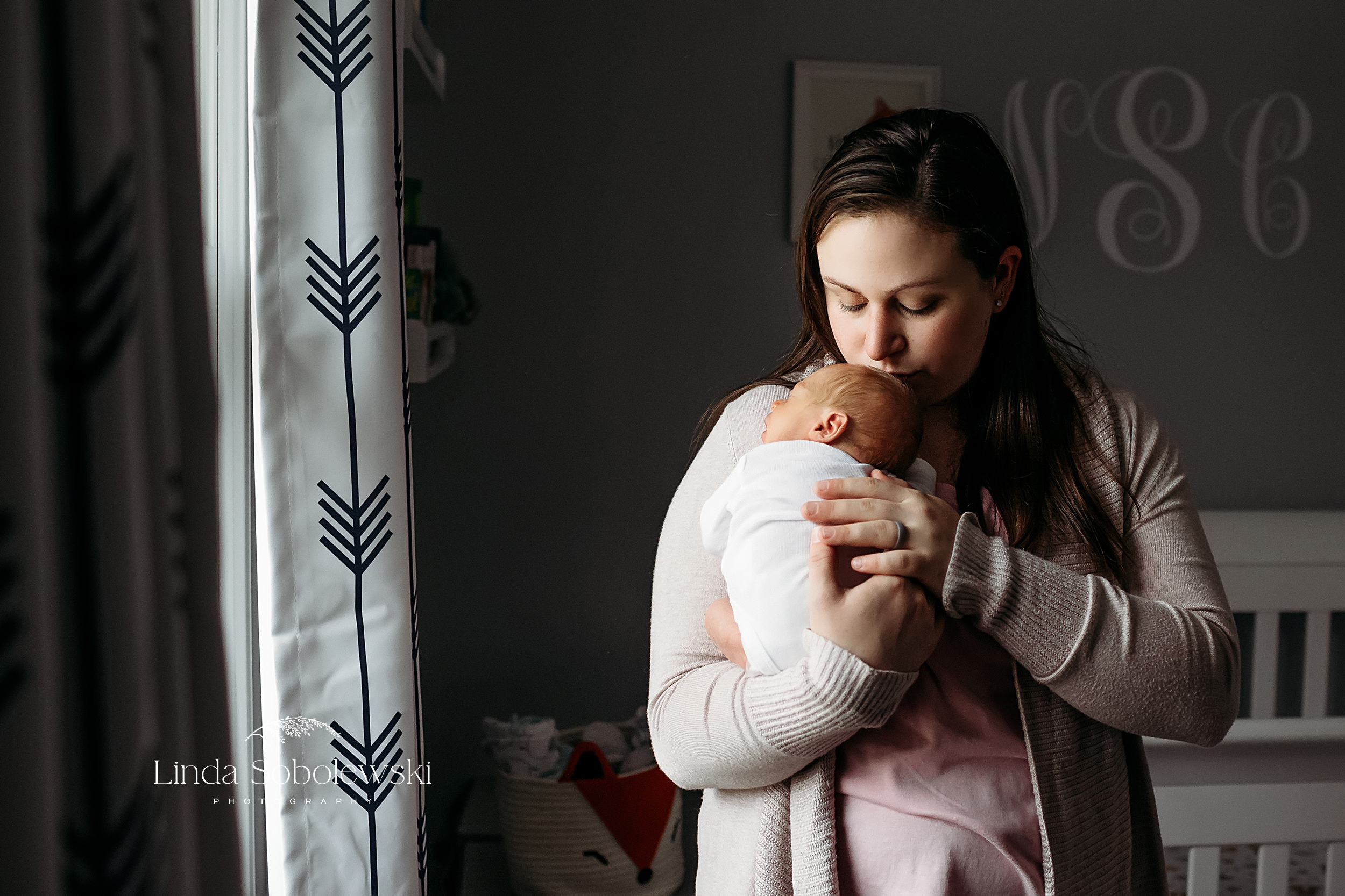 mother holding her newborn baby, Guilford CT Best Newborn Photographer