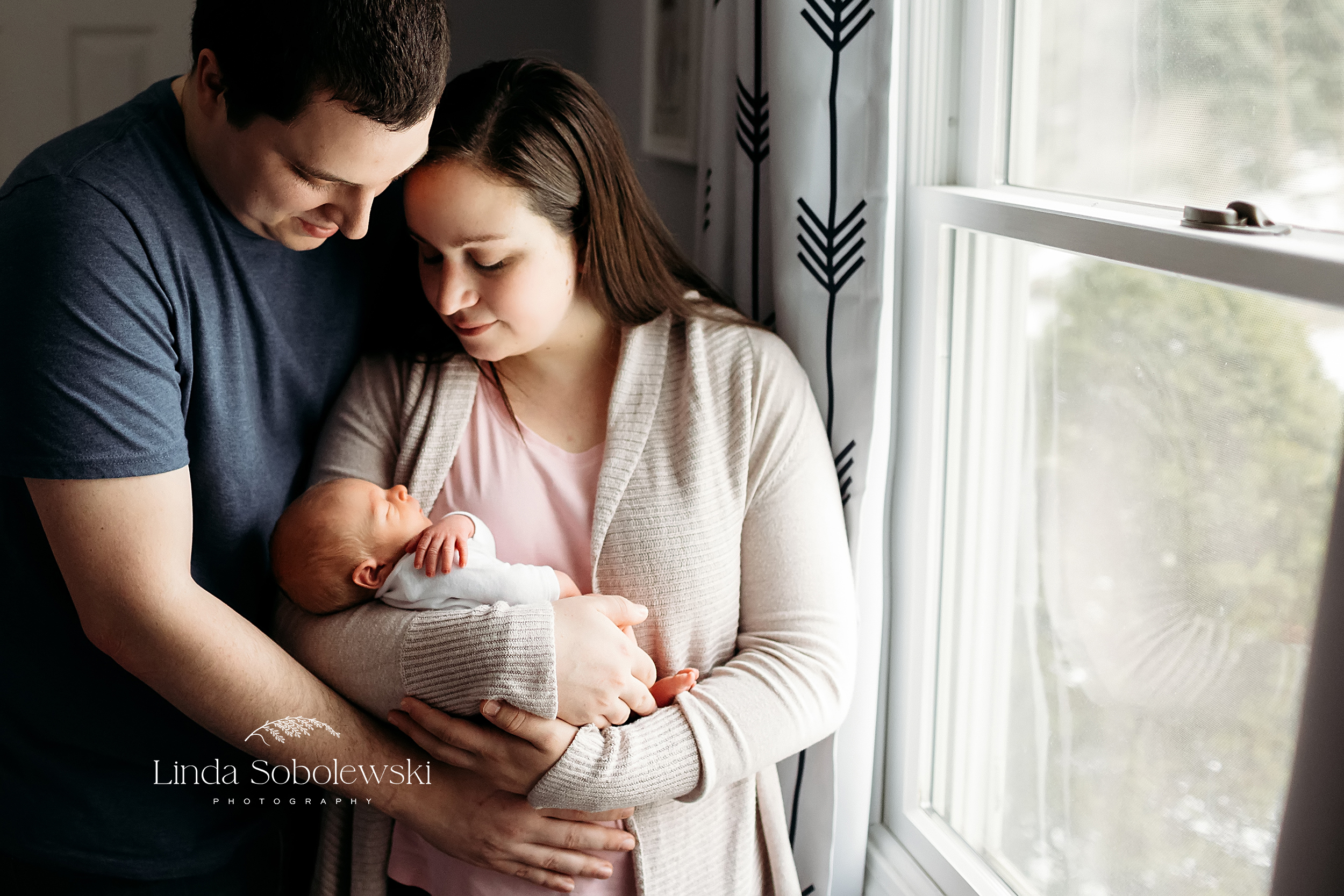 parents looking down at their newborn baby, Guilford CT Newborn photographer