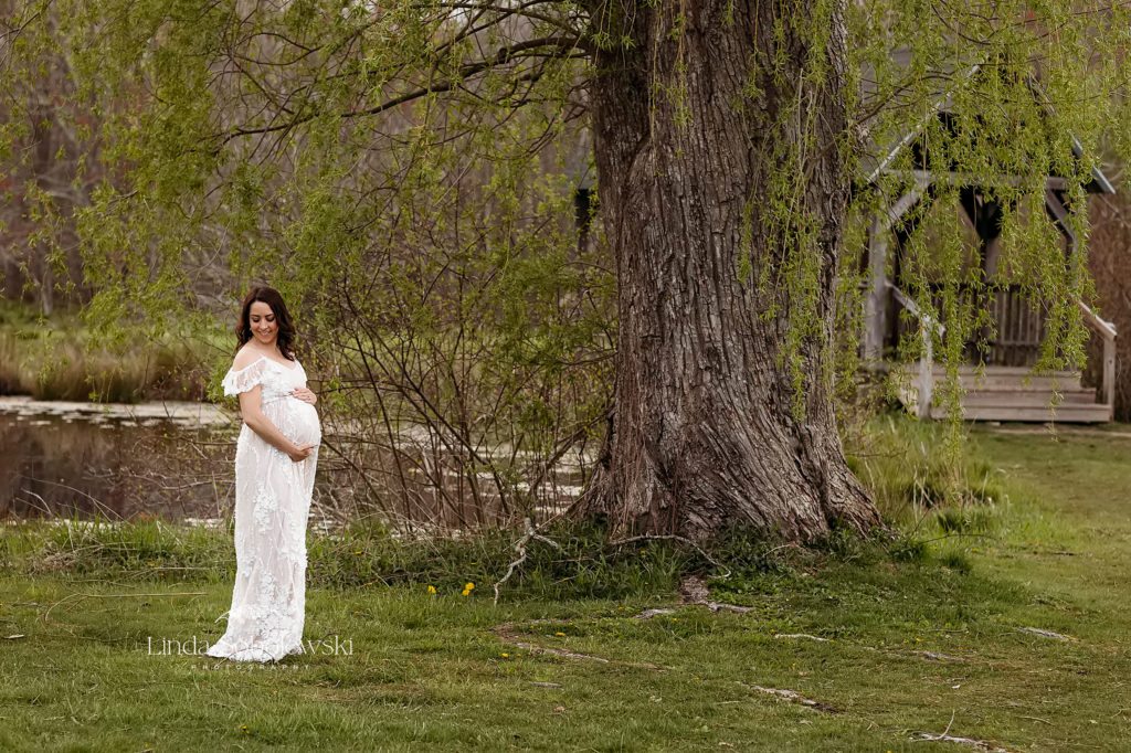 expectant woman in white dress under a tree, Branford CT photographer
