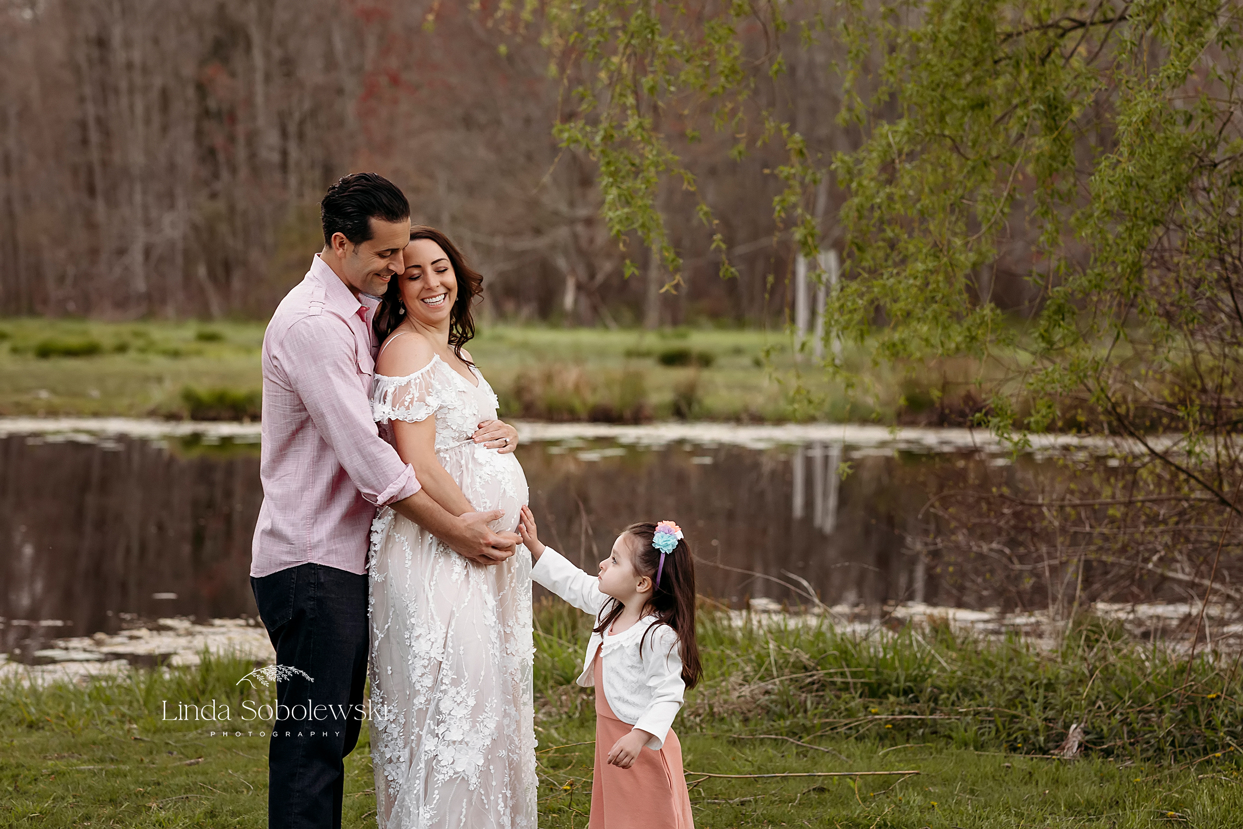 little girl putting her hand on her expectant mama's belly, CT Maternity photographer