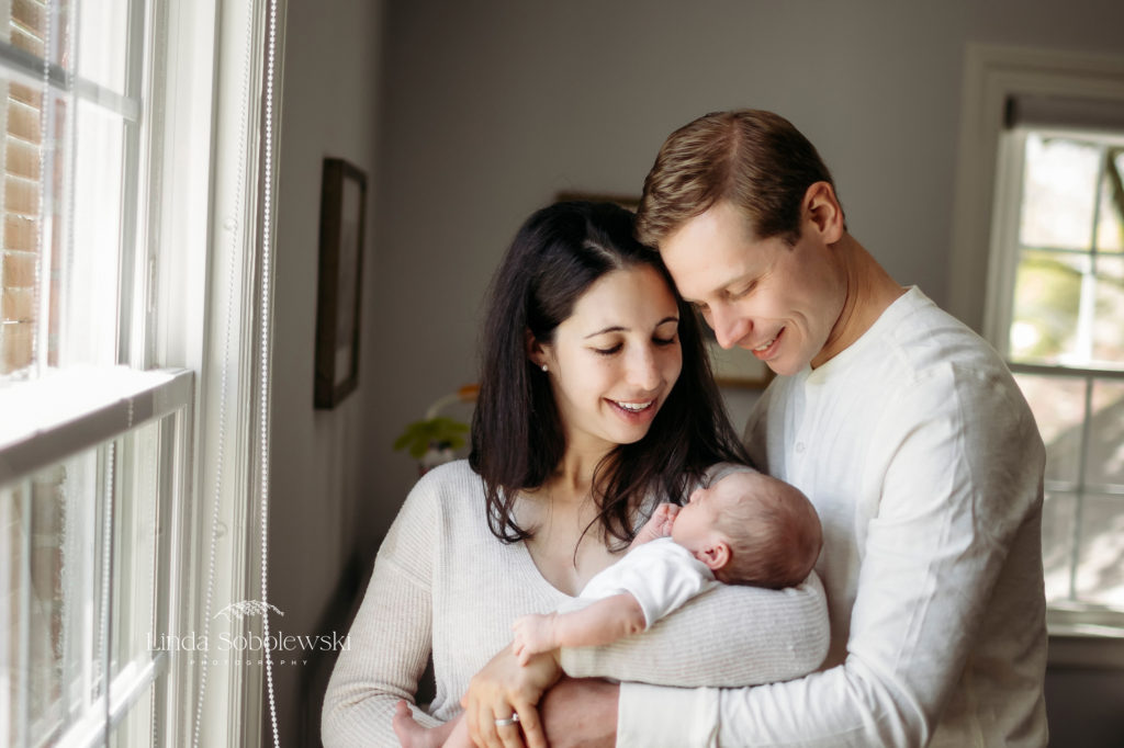 parents holding their new baby, CT Lifestyle Newborn Photographer