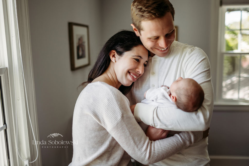 parents holding their new baby, CT Lifestyle Newborn Photographer