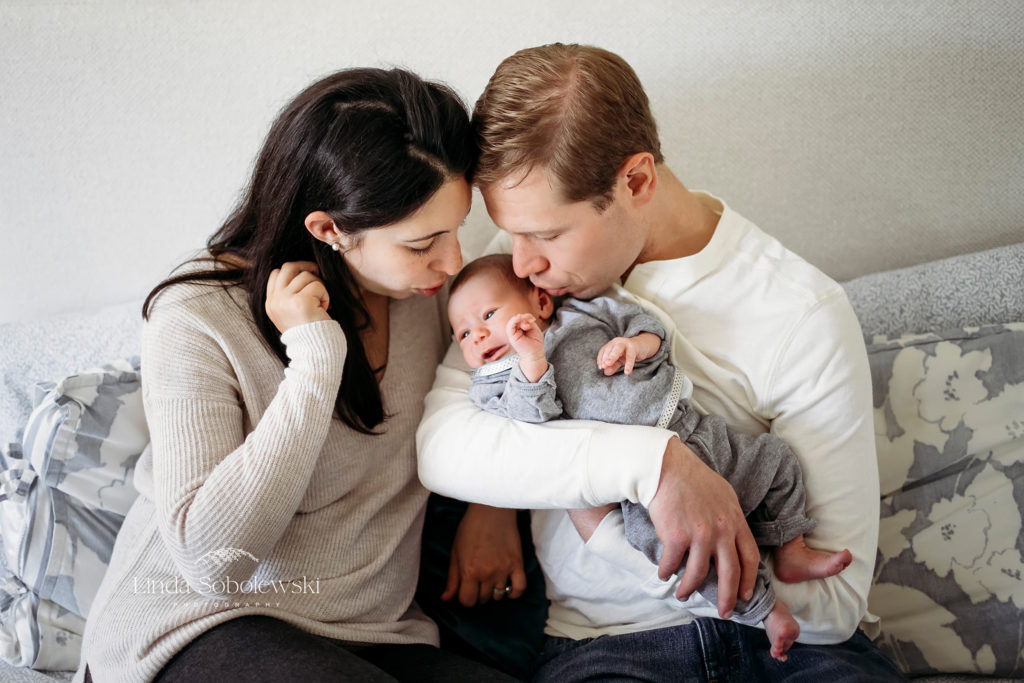 parents kissing their new baby boy, Hamden CT newborn photographer