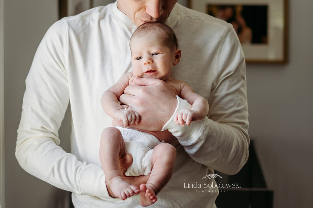 dad holding his newborn baby girl, CT Lifestyle Newborn photographer