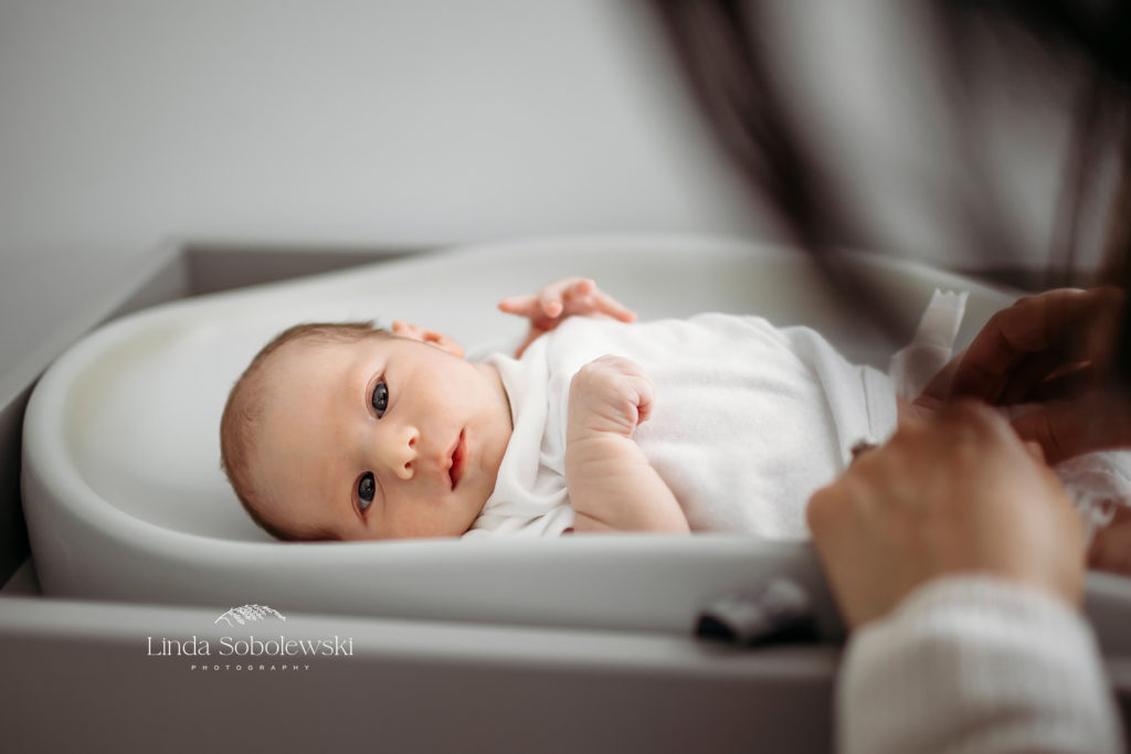 newborn baby boy getting his diaper changed, CT Best newborn photographer