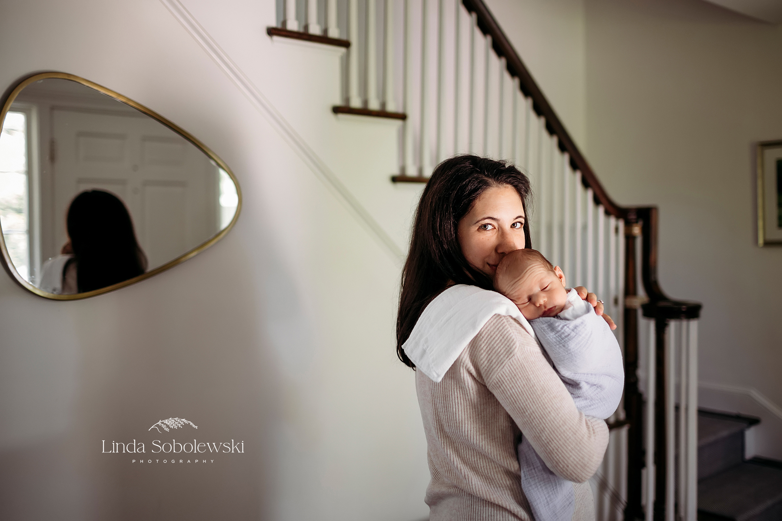 woman in dark hair holding her newborn baby, Branford CT newborn photographer