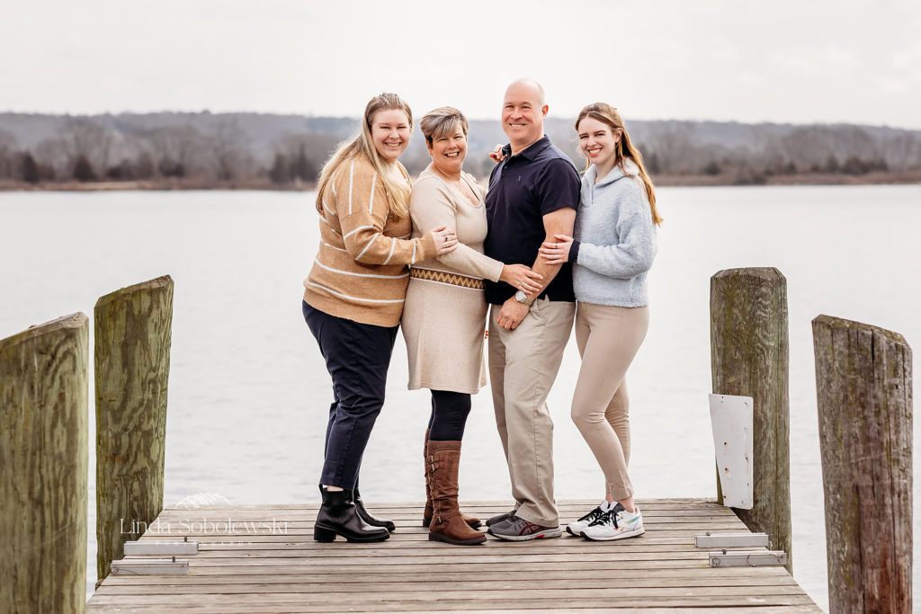 family of four standing together on a pier, Essex, CT Extended Family Photographer