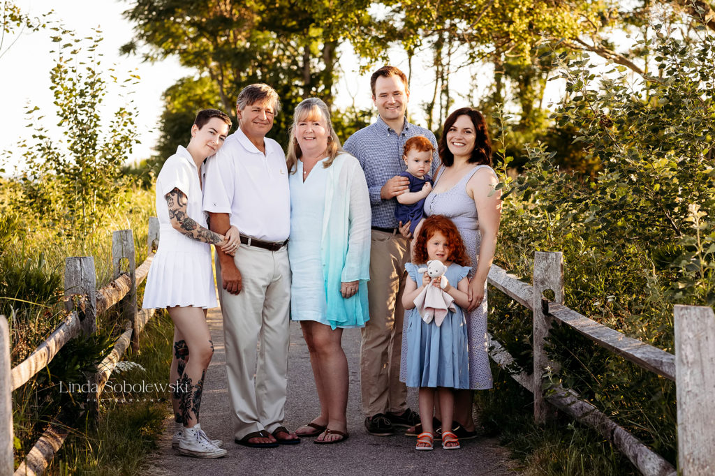 family posing together at the beach for a large family photo shoot in Madison, CT