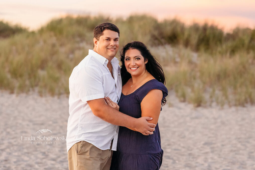 woman in navy blue dress with husband in white shirt, CT shoreline photographer