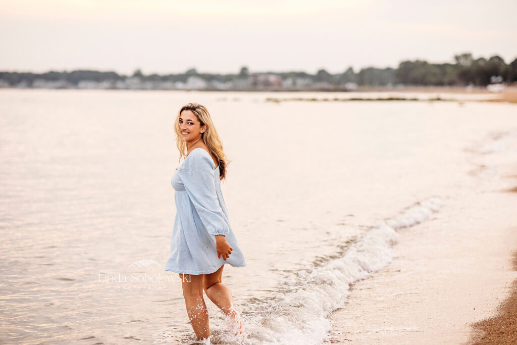 girl in blue dress playing in the ocean, Madison CT Senior Photographer
