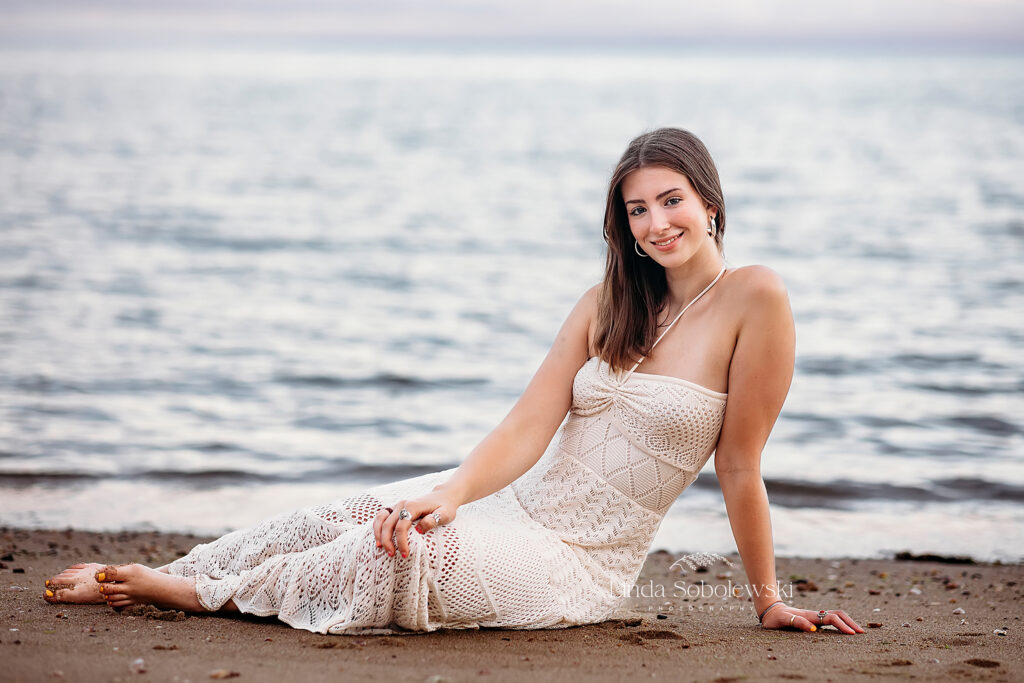 girl in long white dress sitting at the beach, CT Best Senior Photographer
