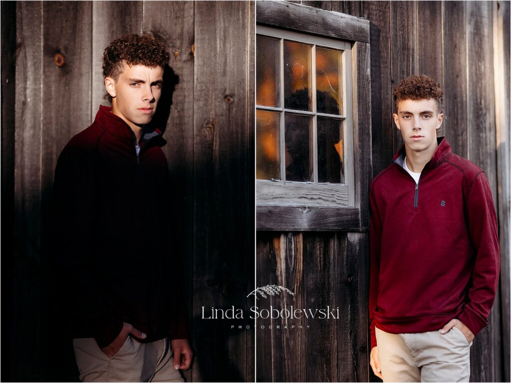 young man wearing a red sweater leaning against a barn wall, CT Shoreline Best photographer near me
