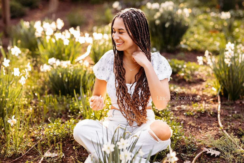 girl with long black braids sitting at the park, CT Senior Photographer