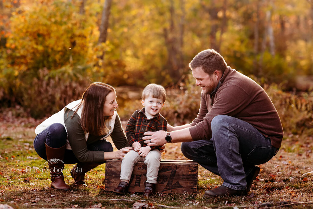 parents playing with their little boy during the fall, Madison CT family photographer