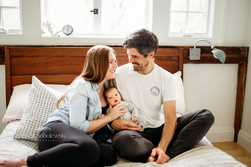 mother and father holding their newborn baby boy, Chester CT newborn photographer