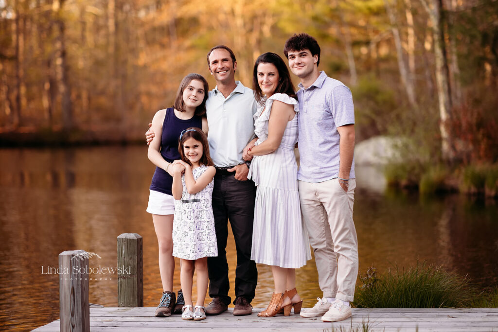 family of five posing together on a dock, CT family photographer