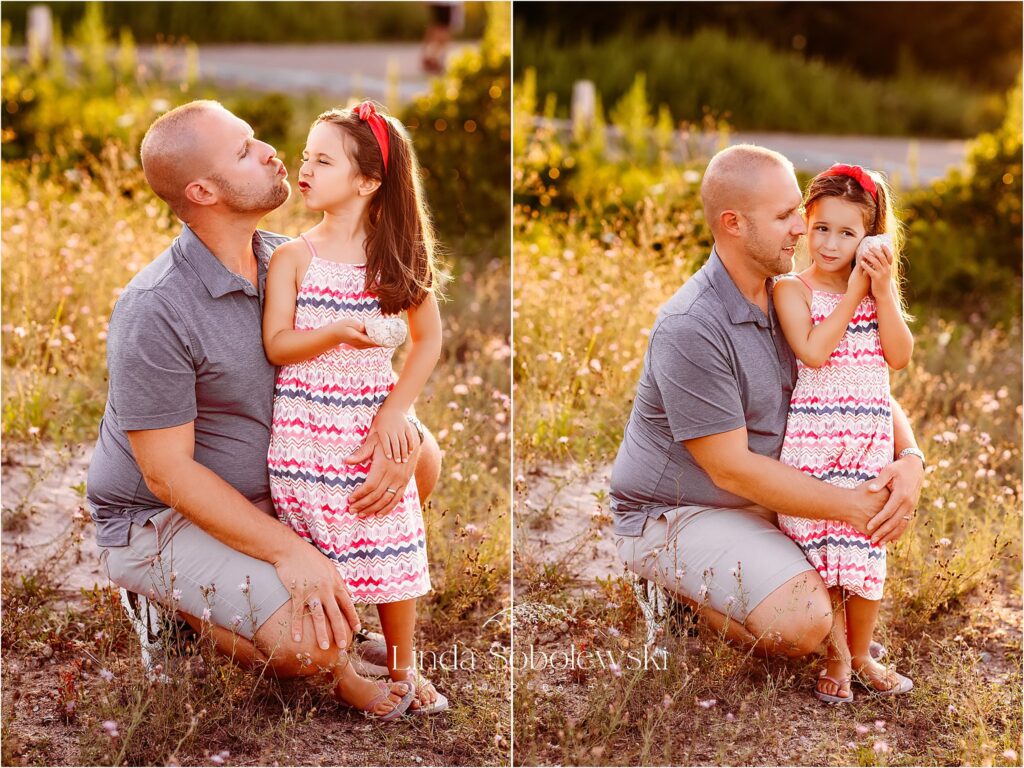 father in blue shirt playing with his little girl at the beach for a beautiful family session, CT Senior Photographer