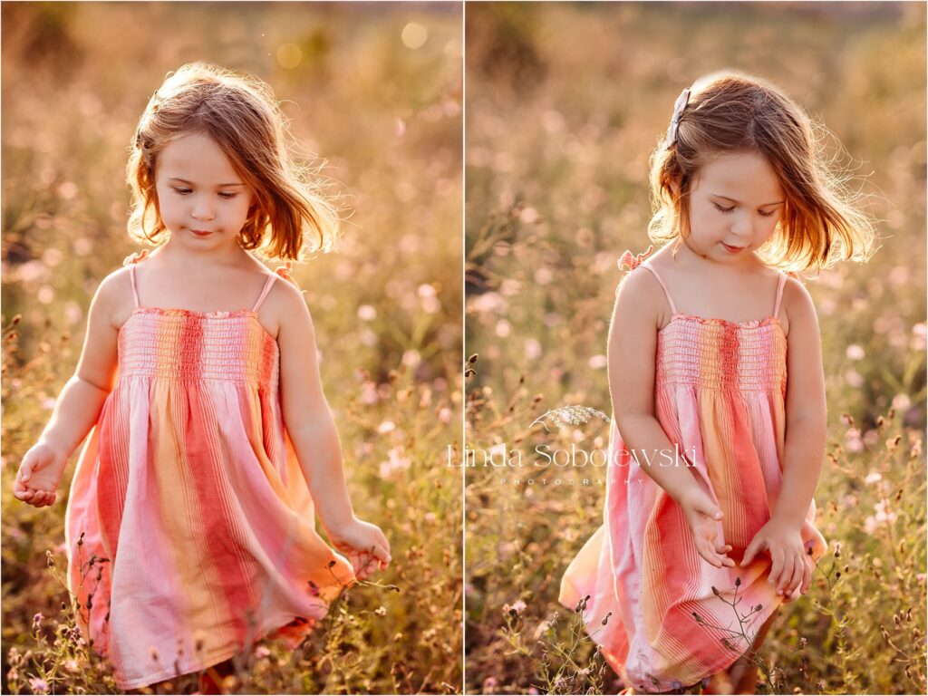 little girl in pink dress playing in the flowers