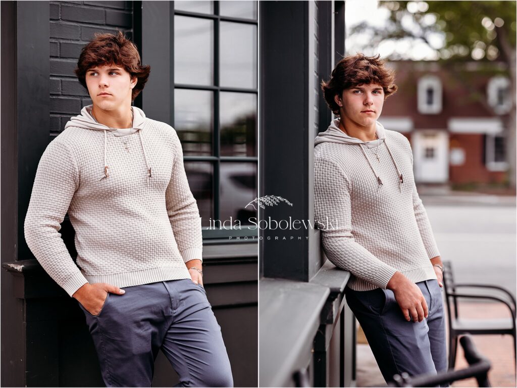 teenage boy in brown sweater leaning against a green building, High School Senior Boy photo session