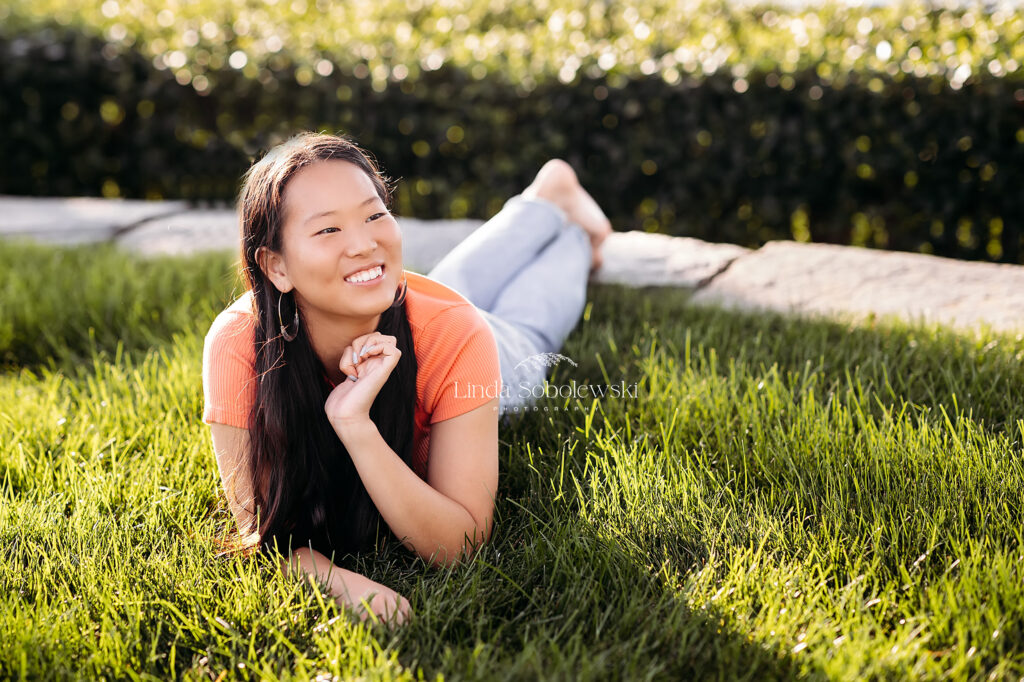 girl laying down on the grass, Senior Session at Hammonasset Beach in Madison CT