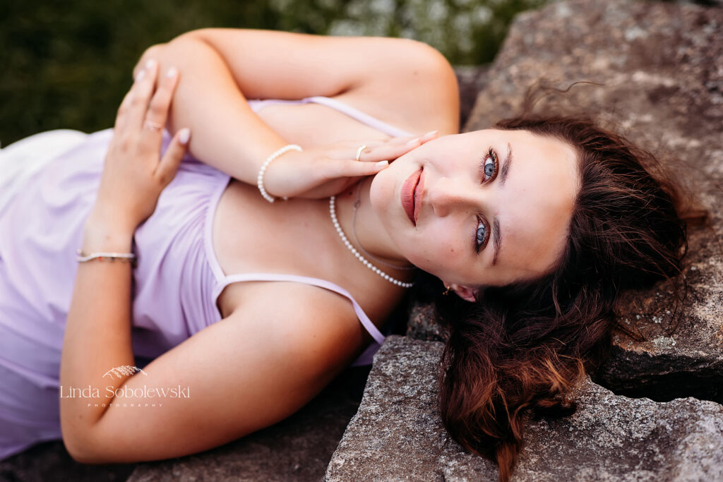 girl in purple dress laying down on steps, CT senior photography