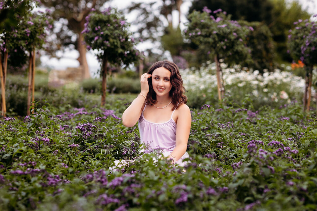 girl with black hair and purple dress in a garden, Senior Photos at Harkness Park