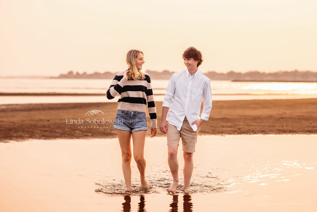 teenage brother and sister walking together at the beach, Summer night petite sessions for 2023 with CT Family photographer