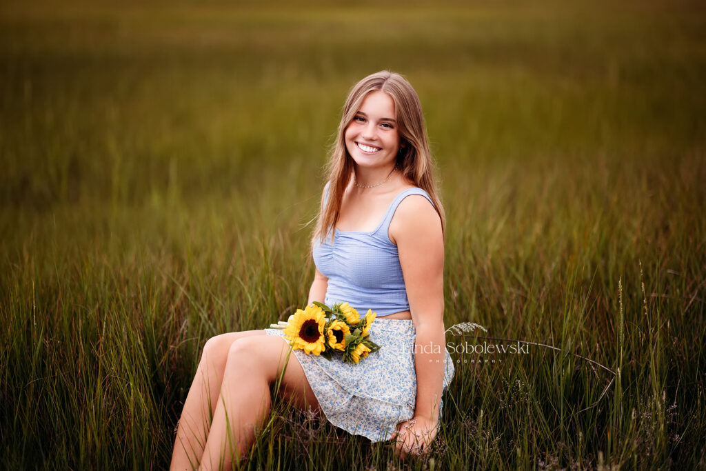 pretty girl blue skirt holding yellow sunflowers