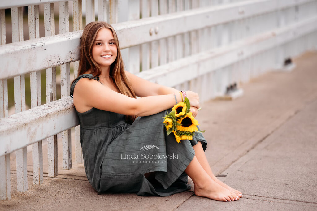 pretty girl in green dress holding yellow sunflowers, CT Senior Photography Session