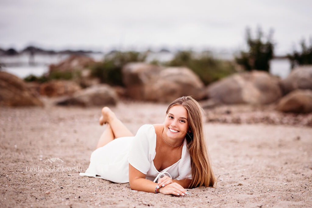 girl laying on her stomach on the beach, Old Saybrook CT photo session