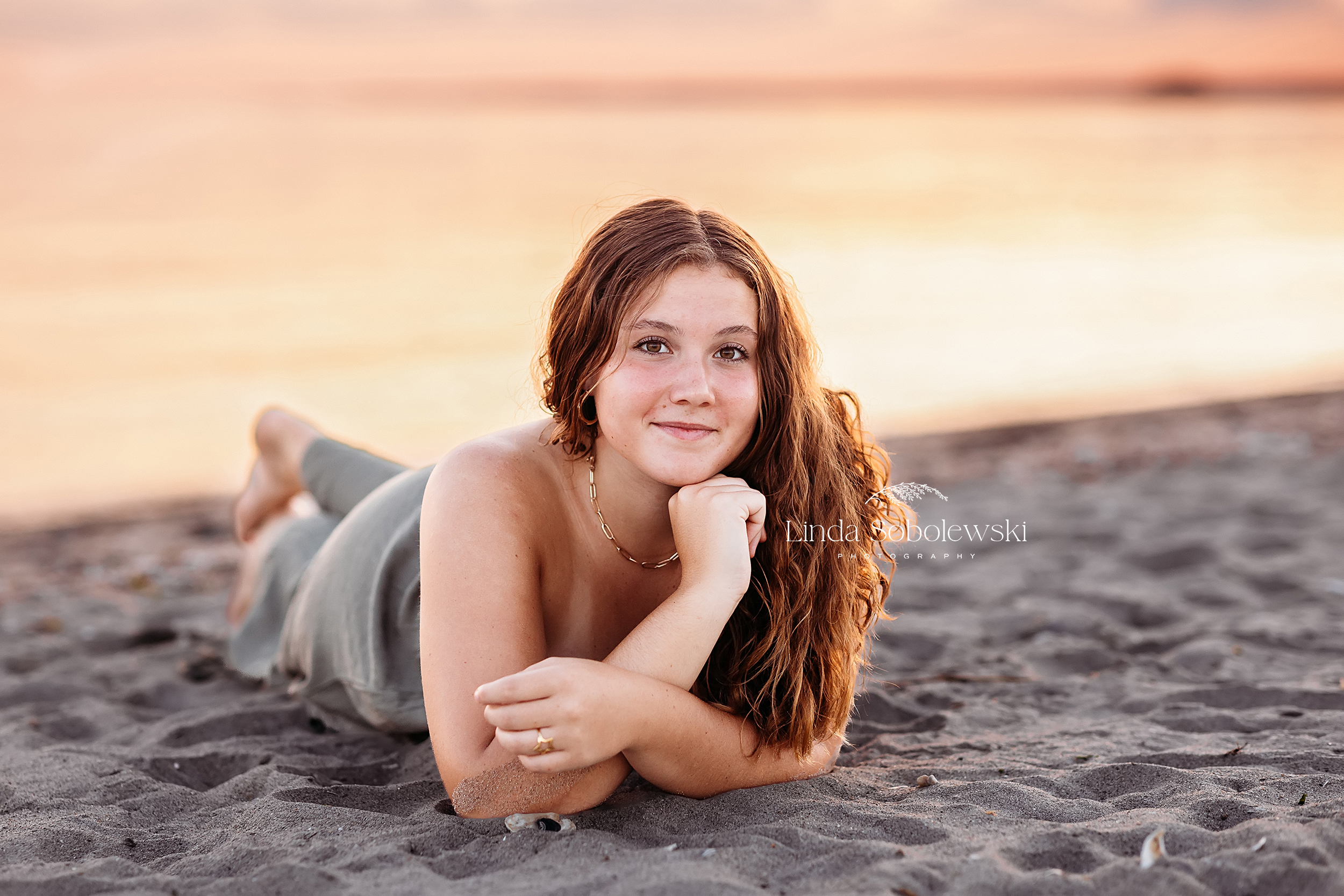 pretty girl laying on the beach, Senior photos on the beach at Hammonasset in Madison, CT
