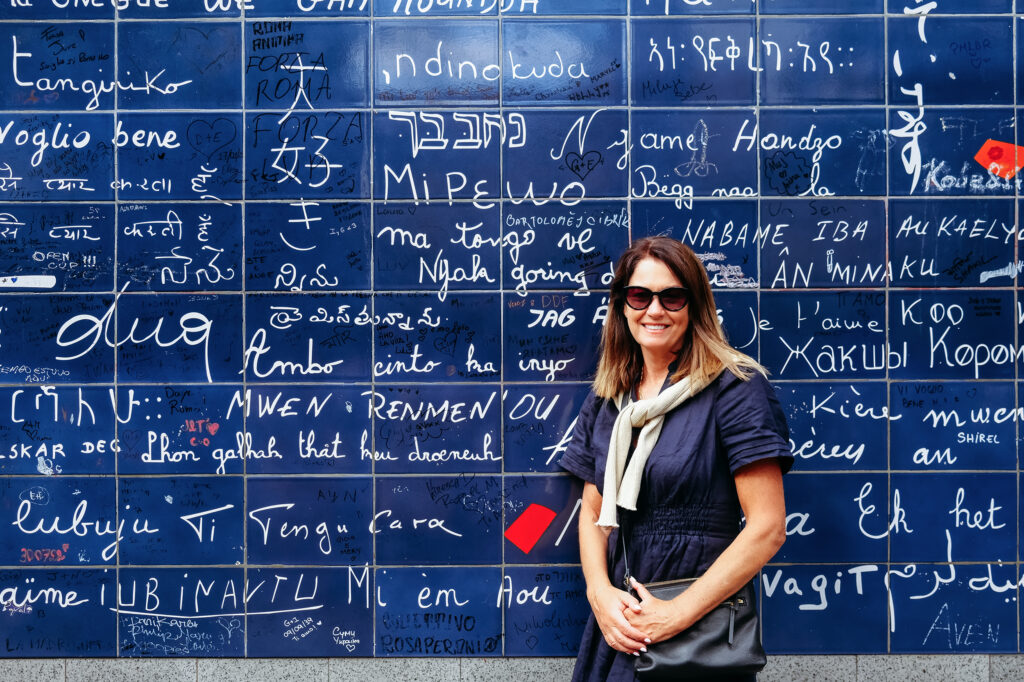 woman standing in front of a blue wall of love, CT photographer