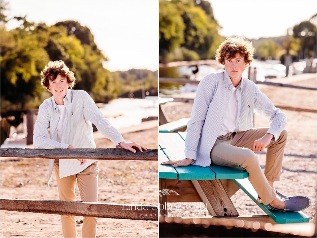 boy in blue shirt and tan pants standing and sitting down, CT shoreline photography session