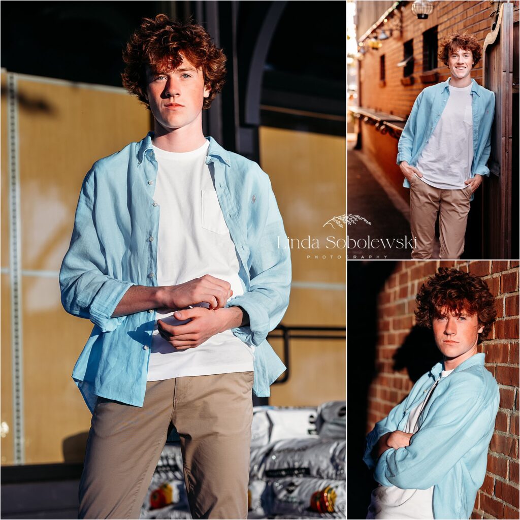 teenage boy in blue shirt standing against a brick wall for his urban senior session, CT shoreline best senior photographer