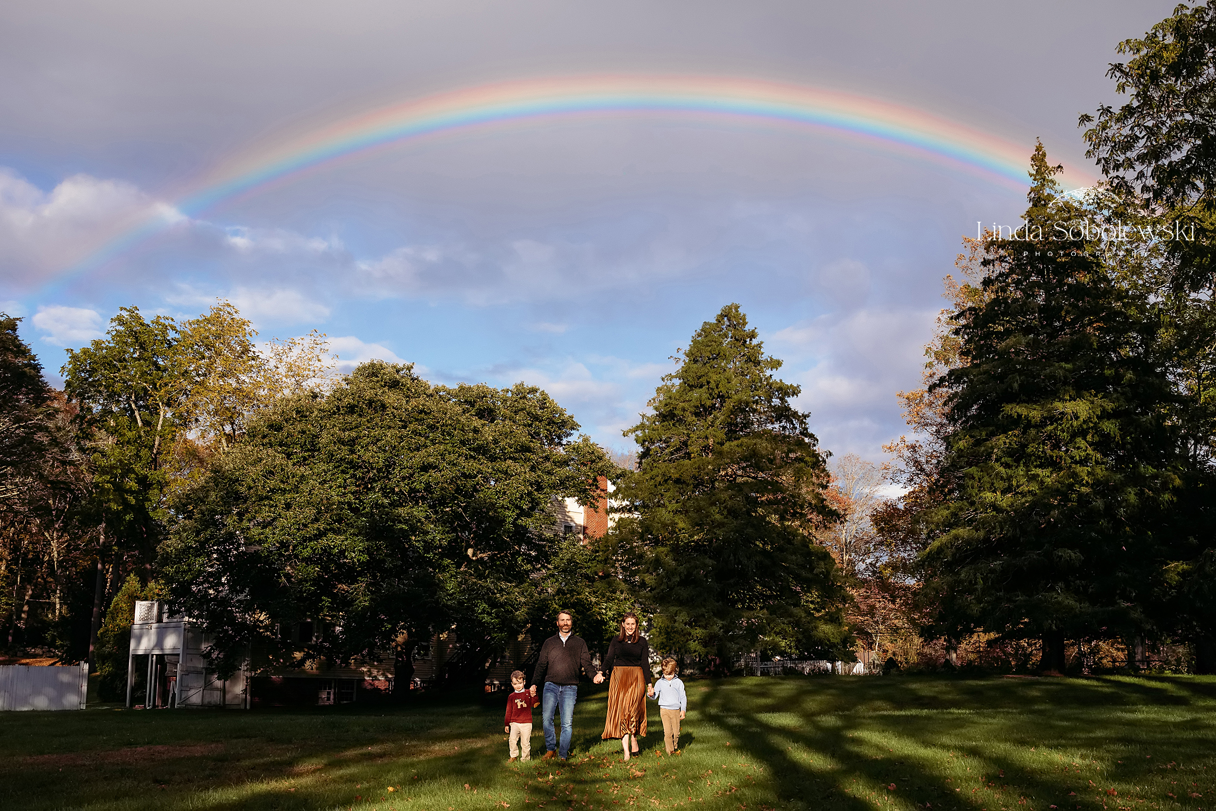 family of four walking under a rainbow, CT Family photographer