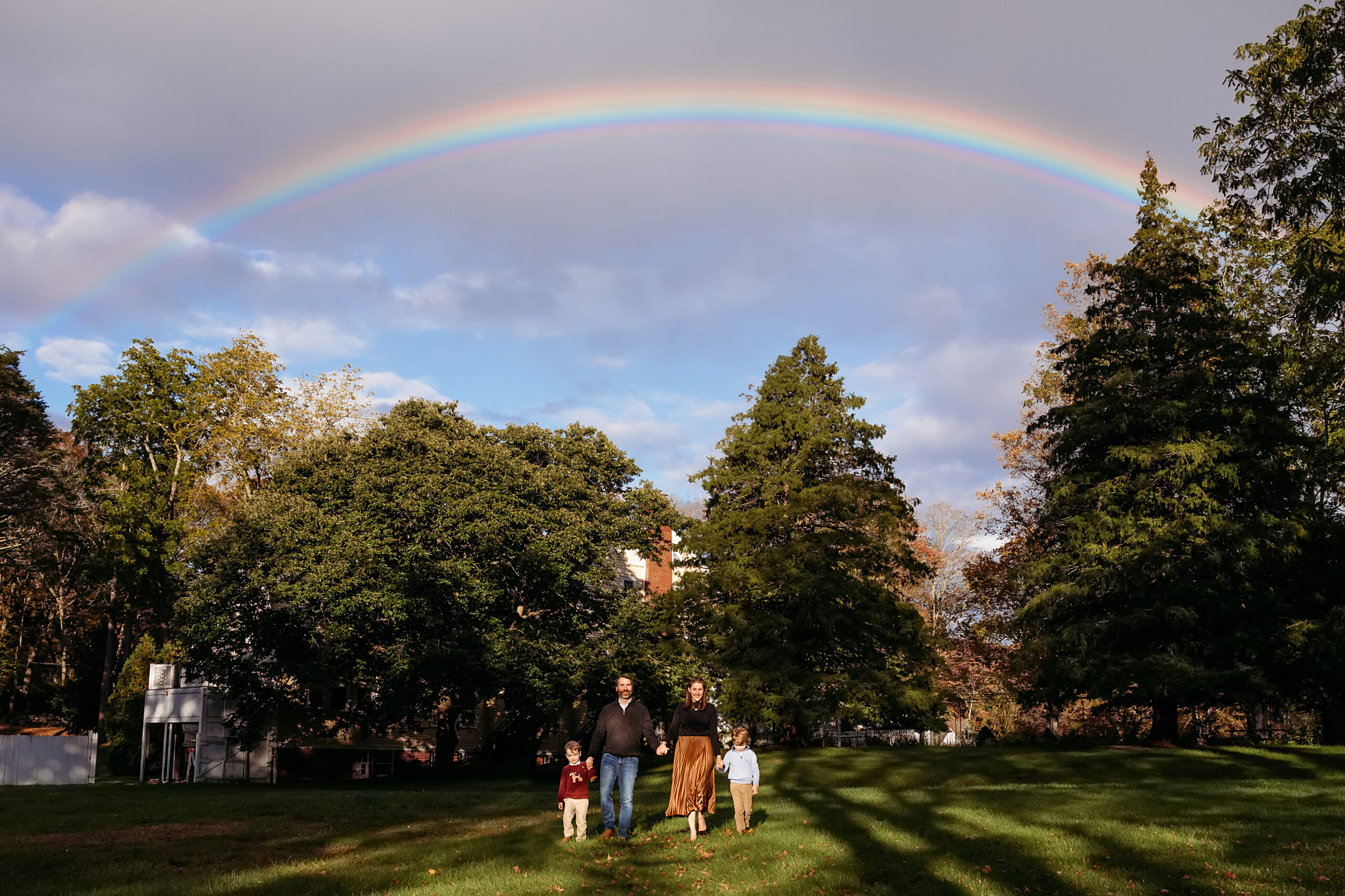 family of four walking under a rainbow, CT Family photographer