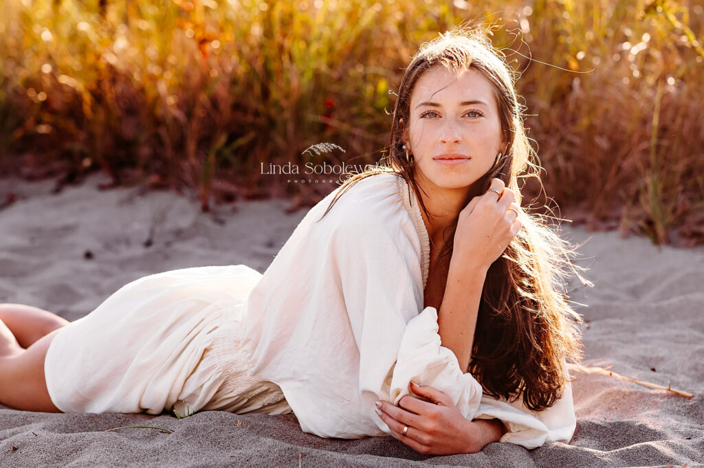 girl in white dress at the beach for her senior photo session at Hammonasset Beach, Madison CT photographer