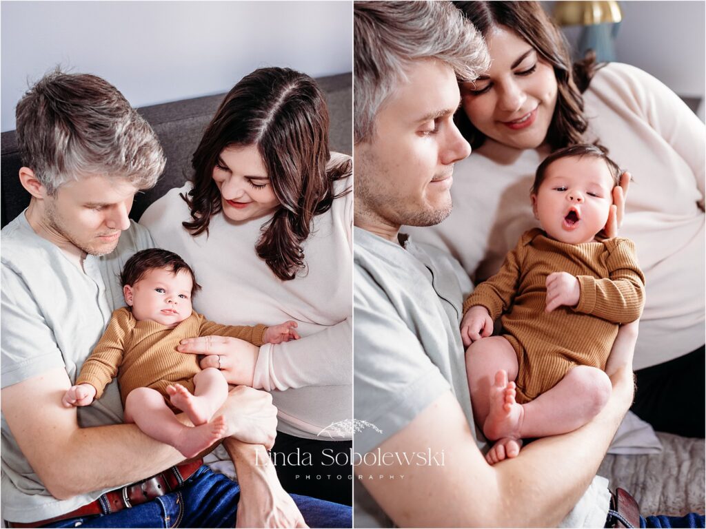 mother and father holding their newborn baby in bed, CT Best newborn photographer