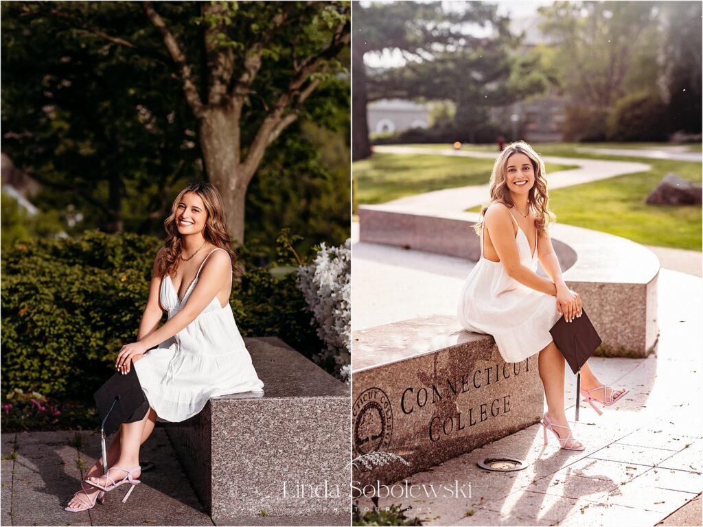 young woman in white dress sitting on a stone wall for her graduation photo session in CT