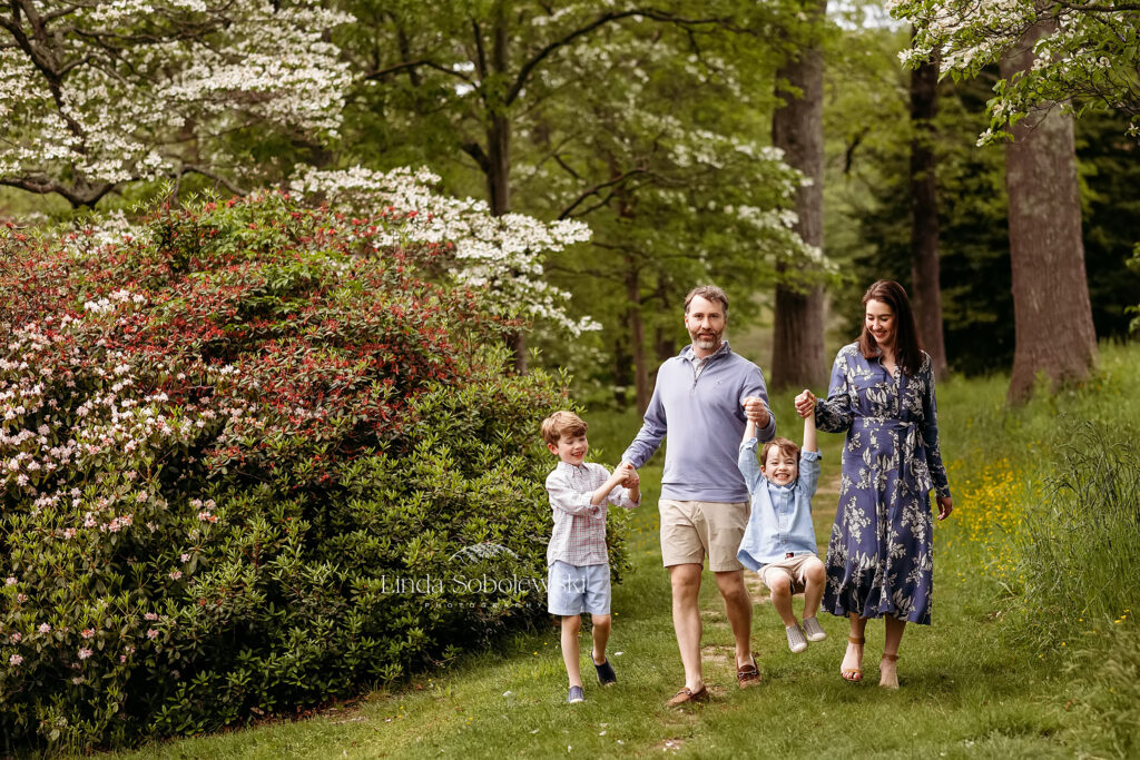 family of four walking in a garden for spring family photos, CT arboretum photographer